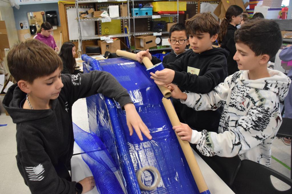 students touching blue slide